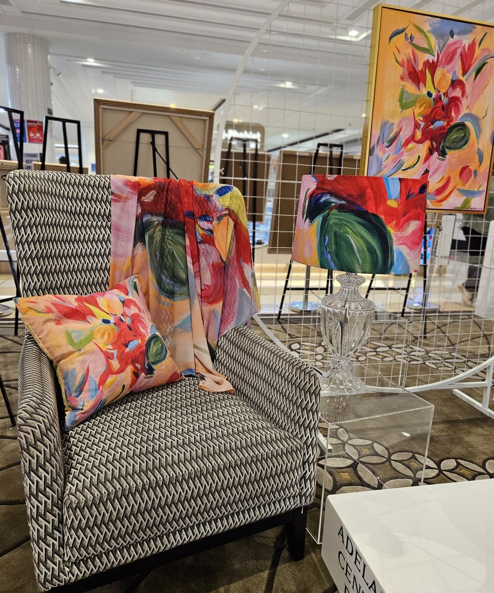 Armchair styled with cushion, throw and lampshade featuring Natalie Gardner's artwork