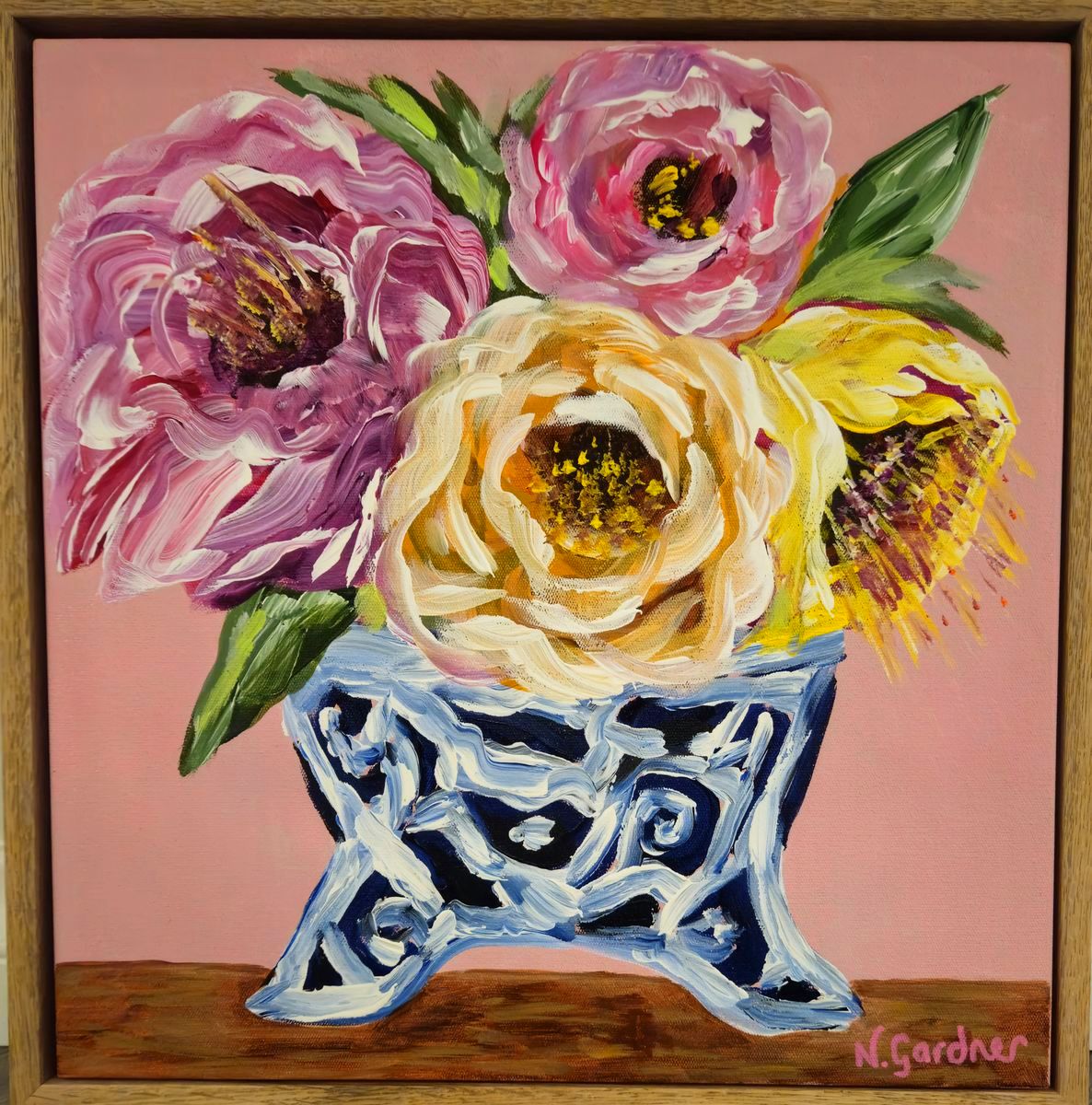 Original painting of pink and golden blooms in a blue and white footed vase on a soft pink background, framed in solid oak